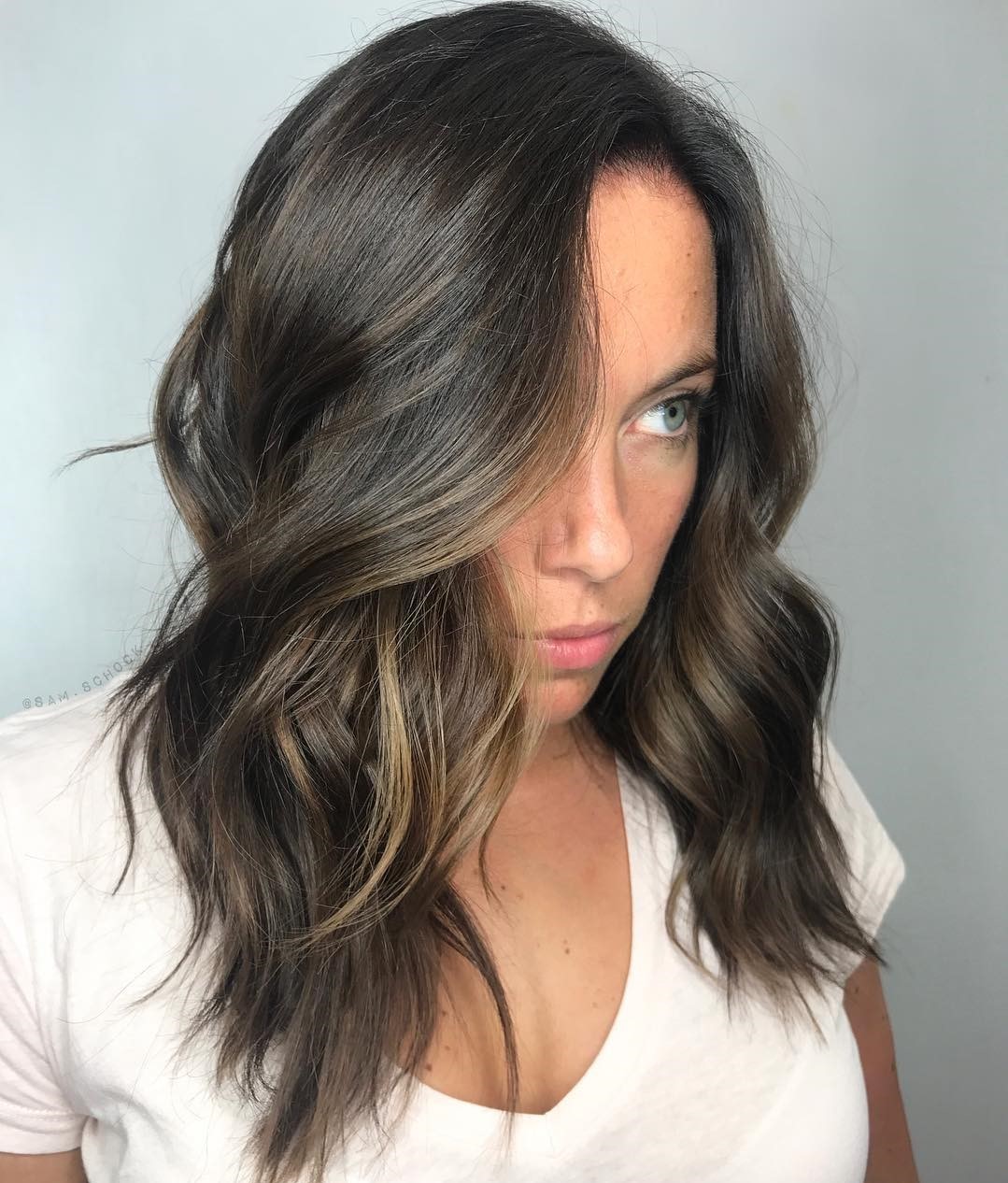Medium Choppy Cut with Waves and a Side Part