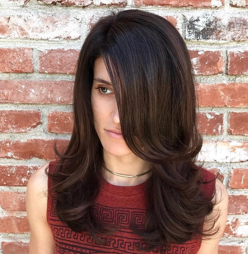 Dramatic Brunette Hairstyle with a Deep Part