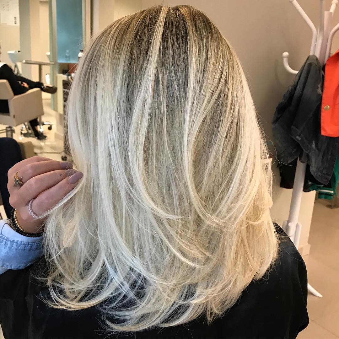 Medium Blonde Layered Hair with Dark Roots