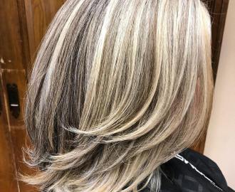 mid-length gray blonde hairstyle with long layers